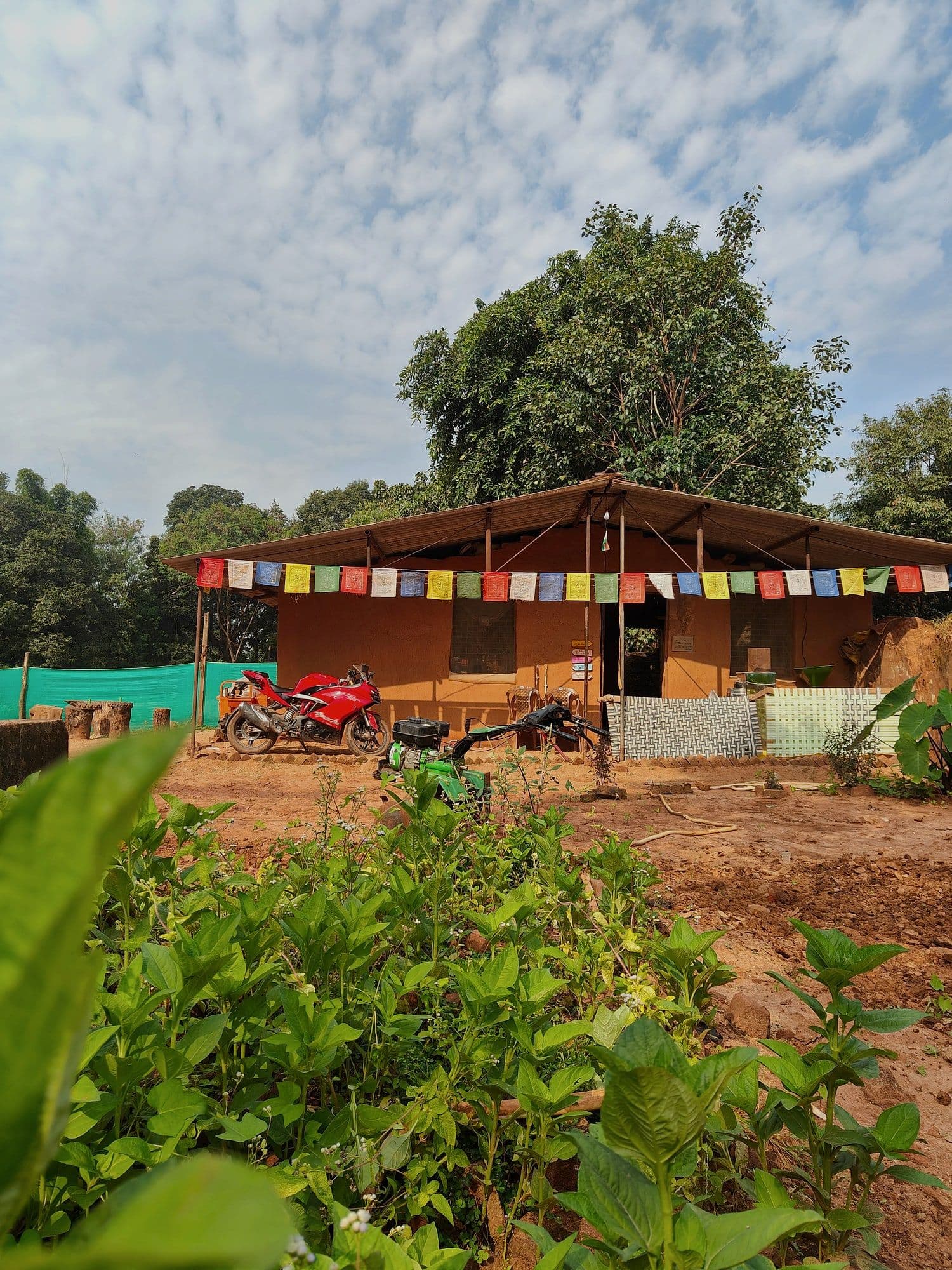 The two-room house Chintamani built by hand on his ancestral land in Makarchuwan, motorcycle parked out front